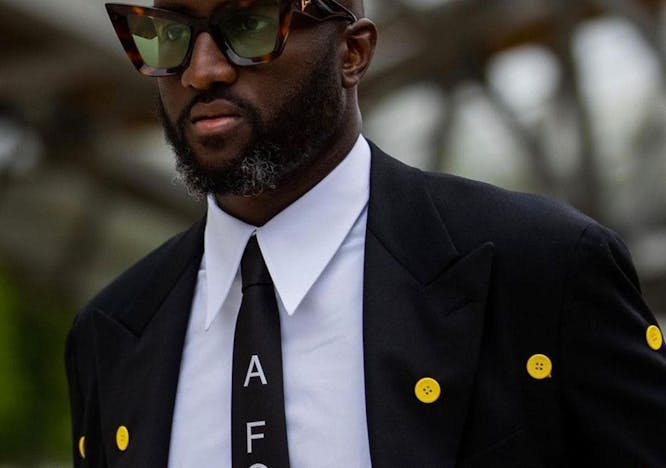 tie accessories sunglasses suit coat overcoat clothing person necktie face