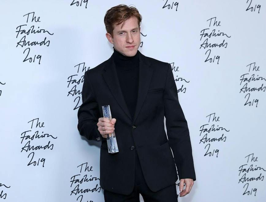 text clothing apparel person human handwriting white board suit coat overcoat