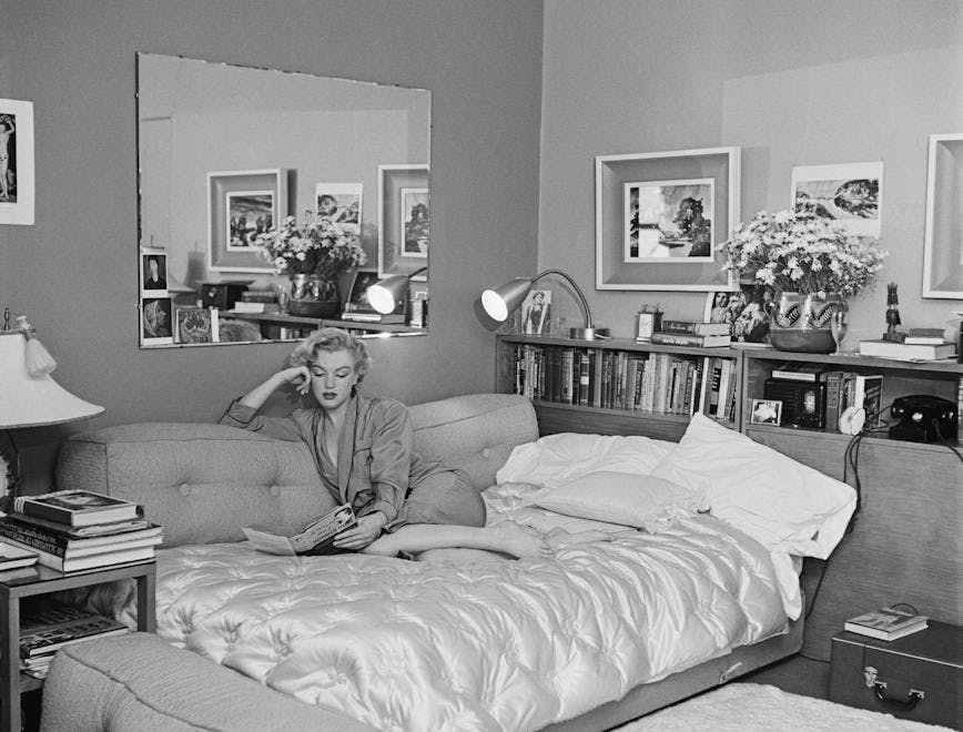 j166182405 neg 13363 a barefoot book diry 18158 indoors living room mirror one woman only reading sitting sofa sofa bed furniture bedroom room bed person human interior design