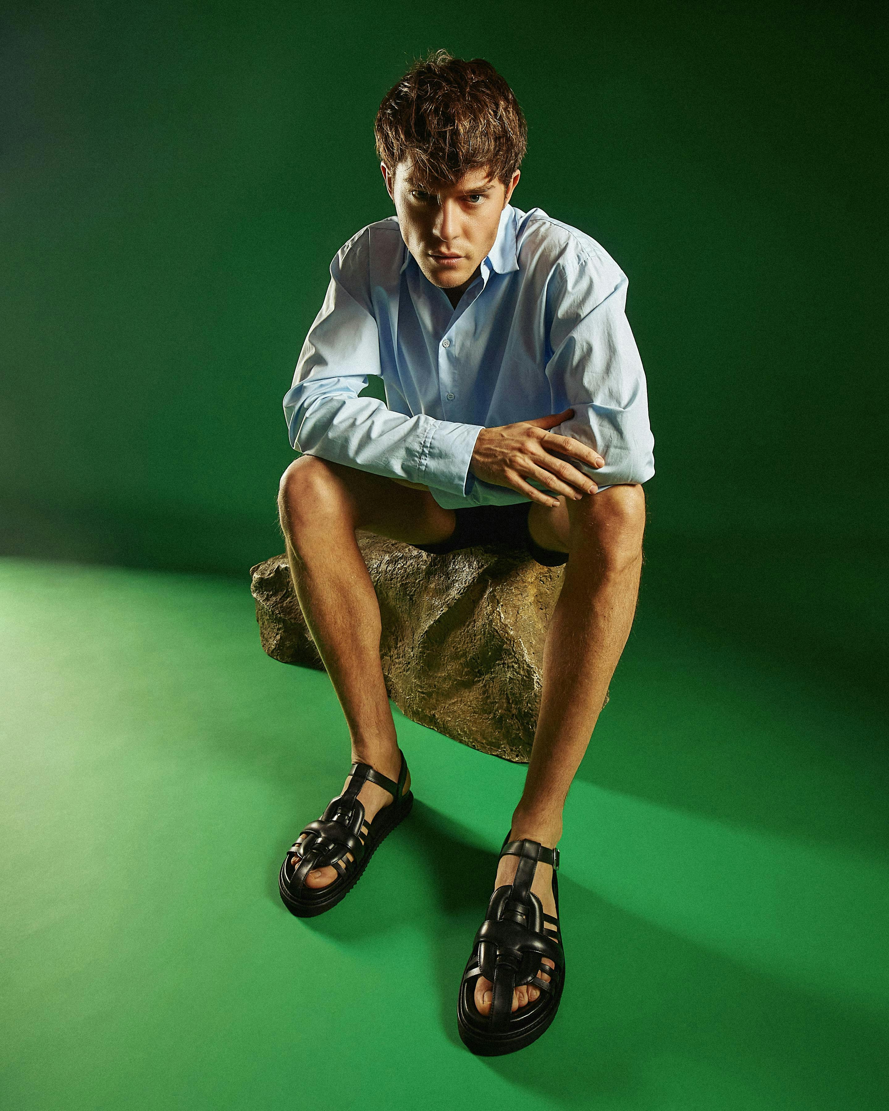 clothing footwear sandal person sitting shoe boy male teen sneaker