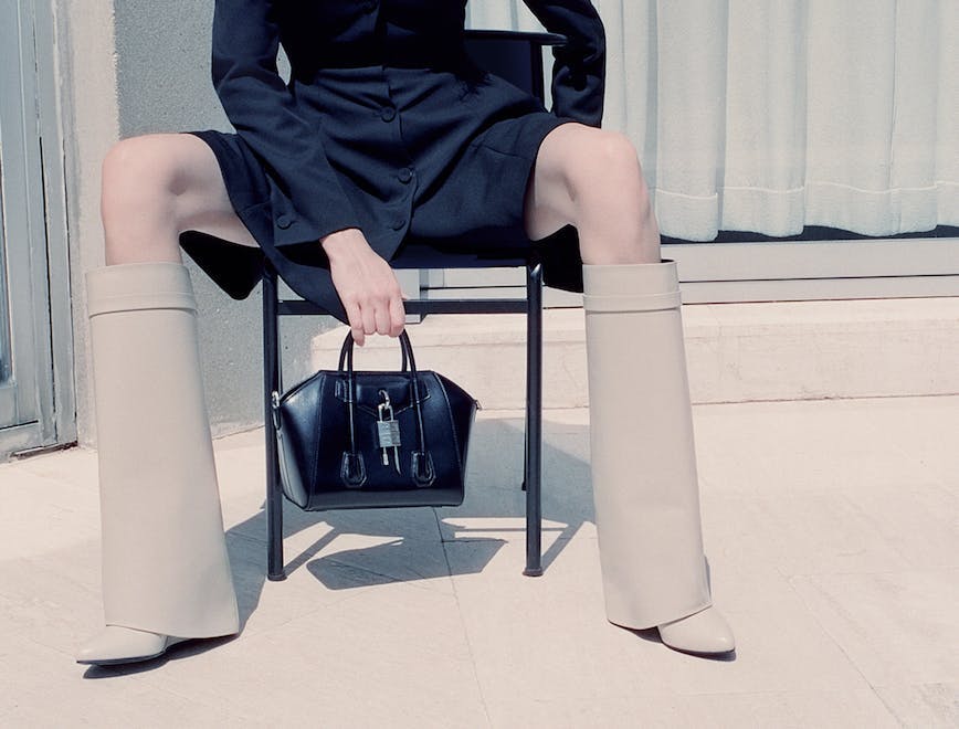 clothing footwear shoe high heel accessories bag handbag person sitting